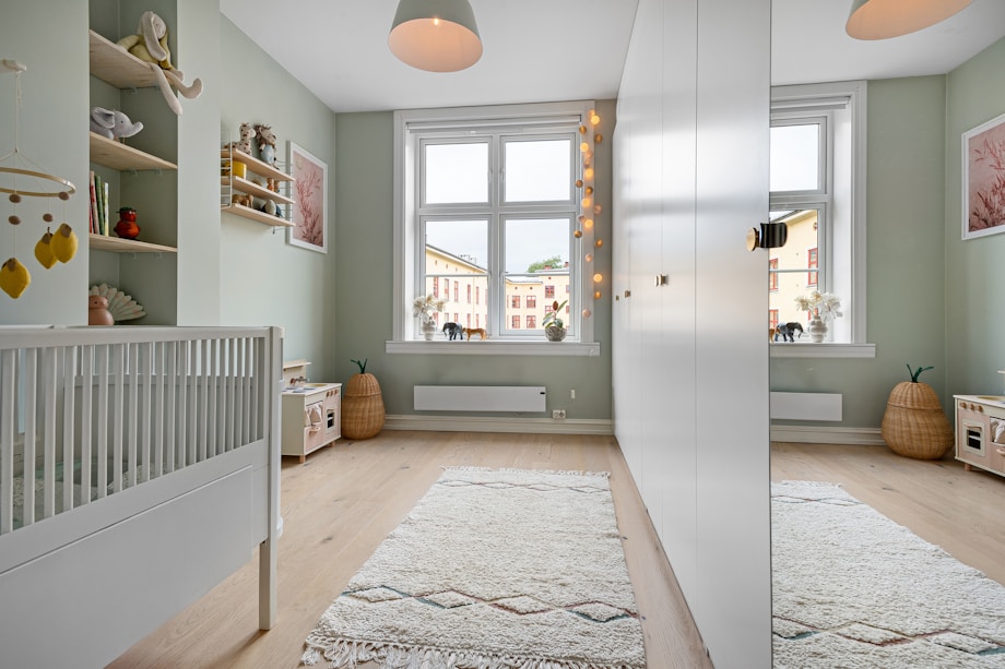 Bright American nursery with white crib and large windows